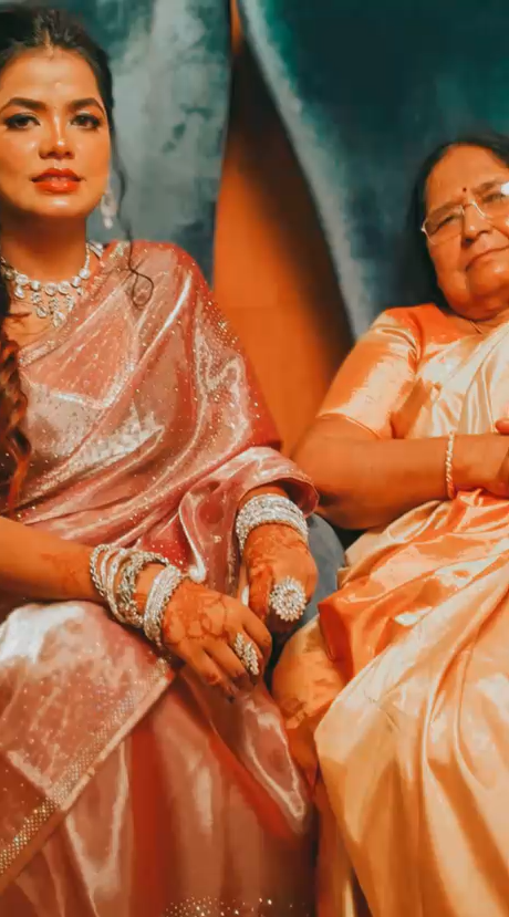 Bengali women in white sarees with red borders during Durga Puja, carrying an ancient lineage forward.